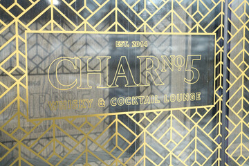 Naklejka premium Art Deco inspired window graphic sign for Char No.5 Whisky & Cocktail Lounge inside Delta Hotel at 75 Lower Simcoe St, Toronto