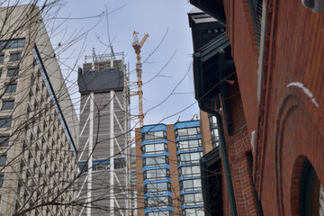 Obraz premium looking up at buildings incl One Bloor West (under construction) from Sultan St and St Thomas St (Bloor Yorkville area), Toronto