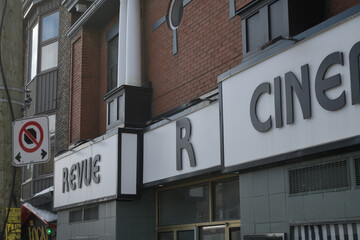 Naklejka premium exterior building facade and detail of sign outside Revue Cinema, a movie theatre, located at 400 Roncesvalles Av, Toronto