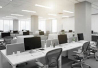 Modern open-plan office interior with rows of computer workstations and natural light