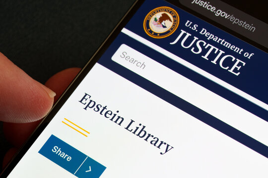Epstein Library on U.S. Department of Justice justice.gov displayed on smartphone screen with DOJ seal, search field and share button in close-up. Stafford, United Kingdom, February 1, 2026,