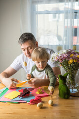 Naklejka premium Father and 3-Year-Old Son Making a DIY Easter Bunny Together at Home