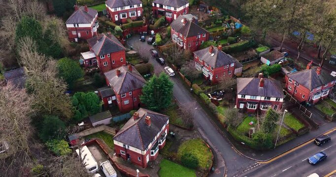 Aerial drone footage of the village of Meanwood in Leeds West Yorkshire UK showing a view of British Cul-De-Sac or dead end street with houses on either side of the street in the winter time