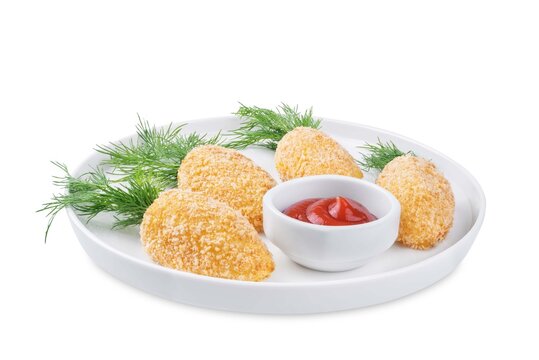 Potato croquettes in the form of carrot in a plate for Easter holidays on a white isolated background