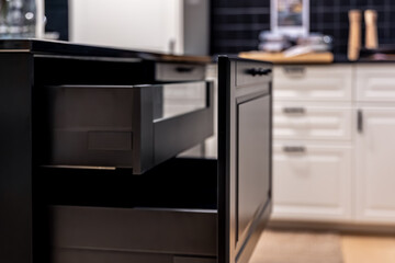 Fototapeta premium Matte black kitchen cabinet with open drawer. Dark aesthetic.