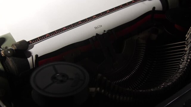 Vintage typewriter printing the word hello on a blank sheet of white paper, symbolizing retro communication, writing, and nostalgic greetings with classic style