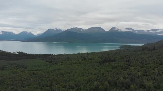 Round view filming, aerial view of Skilak Lake and Alaskan wilderness with trees and mountains near Seward Highway
