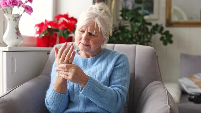 Senior woman suffering from pain in her hand
