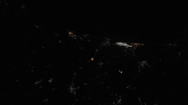 Night satellite fly over of the Port of Gioia Tauro, one of the largest commercial container hubs in the Mediterranean, animation based on Nasa imagery