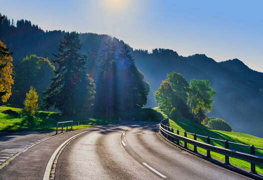Winding Mountain Road with Sunbeams