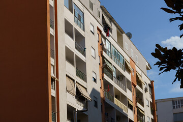 Modern housing apartment block reflecting Mediterranean architectural heritage in an urban setting. Suitable for rental markets, purchasing decisions, relocation service, vacation living, and agencies © Daryna 