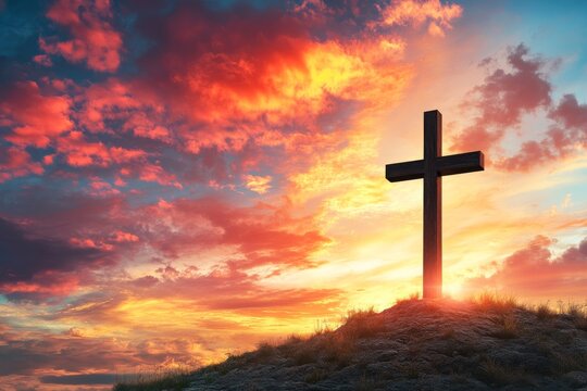 Christian easter symbol shines against colorful sunset sky with cross on hill