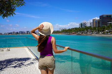 Fototapeta premium Holidays in Brazil. Young woman strolling on promendae in Maceio, Alagoas, Brazil.
