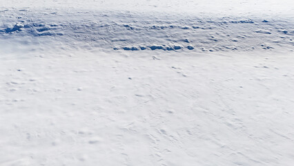 white fresh snow covered land ground from drone aerial photography background nobody