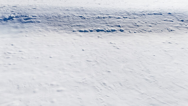 white fresh snow covered land ground from drone aerial photography background nobody