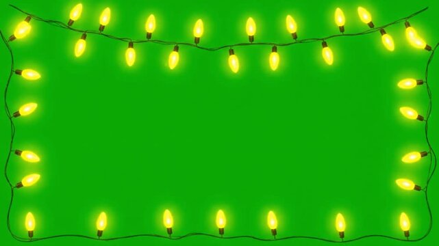 Yellow Christmas lights on green background with copy space