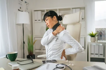 Fotobehang Onderzeeër Female doctor experiencing neck and back pain at work  © Miljan Živković