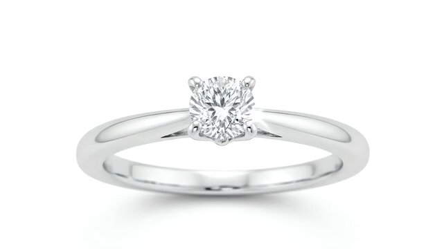 A luxurious solitaire diamond engagement ring, featuring a simple polished white gold band, is captured sparkling brightly in a clean, high-key studio shot against a pure white background.