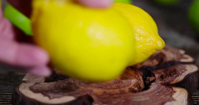 yellow sour lemon and green limes lying on the table, ripe citrus fruits lemons and limes lying on a wooden table