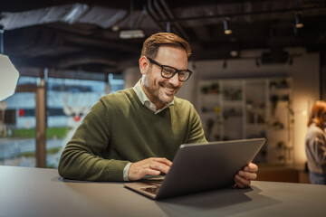 Fototapeta premium Professional man working on laptop in modern office