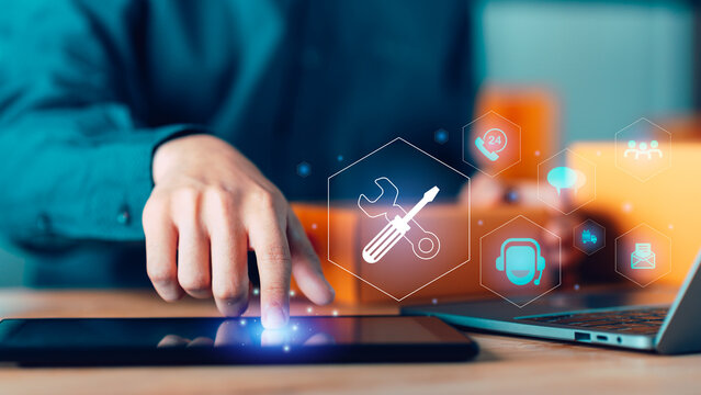 Digital support concept with human hand touching tablet screen and virtual service icons, symbolizing system control, technical maintenance, online support, automation workflow, smart digital services