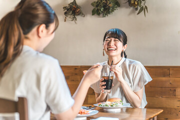 Young Asian women chatting while having lunch in a cafe/restaurant