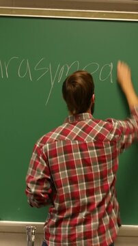  Chemistry Professor Wrting Temr on Chalkboard - Vertical