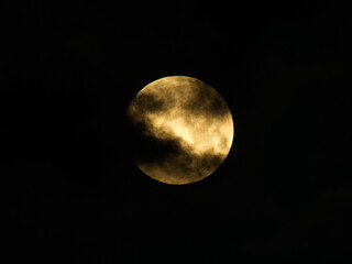 Fototapeta premium Tokyo,Japan - February 2,2026: The full moon covered with Moving clouds at dawn