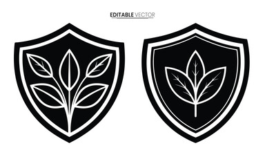 Fototapeta premium Two black shield emblems featuring stylized leaf designs presented as editable vector graphics high quality