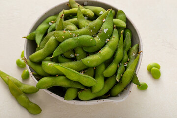 Edamame pods with salt and pepper and a dipping sauce, healthy protein snack
