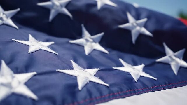 Close-up of American Flag with Stars and Blue Fabric in Highlighted Detail