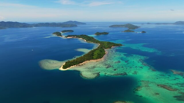 Cinematic drone shot of the pristine White Beach in Port Barton, Palawan, with Inaladelan Island (German Island) visible on the horizon. Tropical paradise in the Philippines