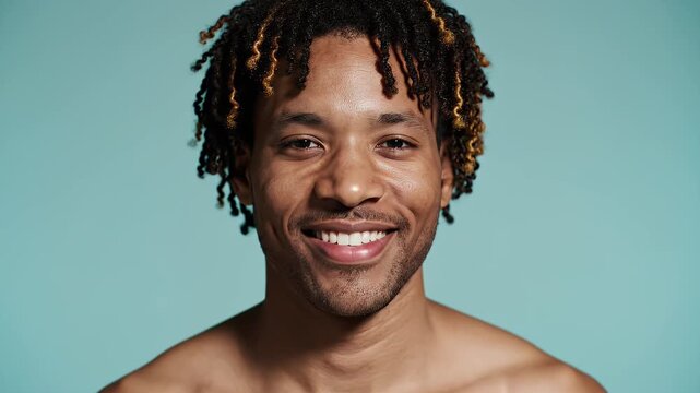 Close Up of Happy Smiling African American Man Against Light Blue Background Portrait with  Dreadlocks Hairstyle Studio