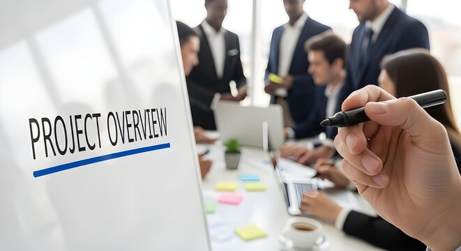 Hand holding a black marker preparing to present project overview details to a diverse business team