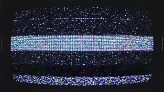A vintage television screen displays a chaotic pattern of glowing white noise static with distinct horizontal bands of colorful pixel interference fro