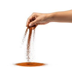 Hand sprinkling vibrant red chili powder from fingers into a small pile isolated on transparent background