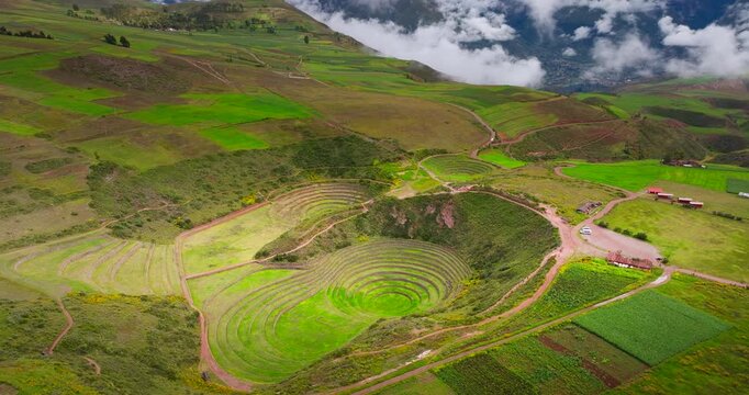 Moray Inca agricultural terraces forming circular patterns in the Andes, aerial panoramic establishing