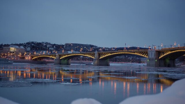 Margaret Bridge (Margit Hid) Crossing The Ice-filled Danube River At Night In Budapest, Hungary. - wide shot