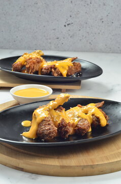Tebasaki is a fried chicken wing dish typical of Nagoya, Japan, served with a drizzle or dip in a savory creamy cheese sauce.