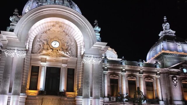 Close-up nighttime view highlighting architectural details of the Palace of the Deposits and Consignments in Bucharest.