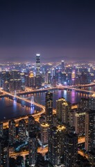 Fototapeta premium Aerial view of a city at night with illuminated buildings, bridges, and a river