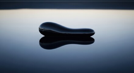 Obraz premium Abstract dark object floating reflected on a glossy surface with blurred background