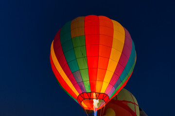 Fototapeta premium colorful hot air balloons glowing against the night sky