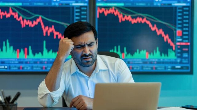 Frustrated stock market indian broker looking at a bearish market