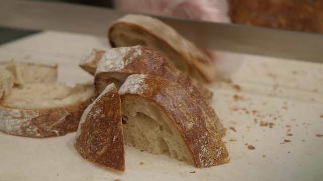 Slicing fresh bread in a bakery in the city