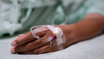 Close up of patient hand with intravenous iv drip, focusing on medical treatment, hospital...