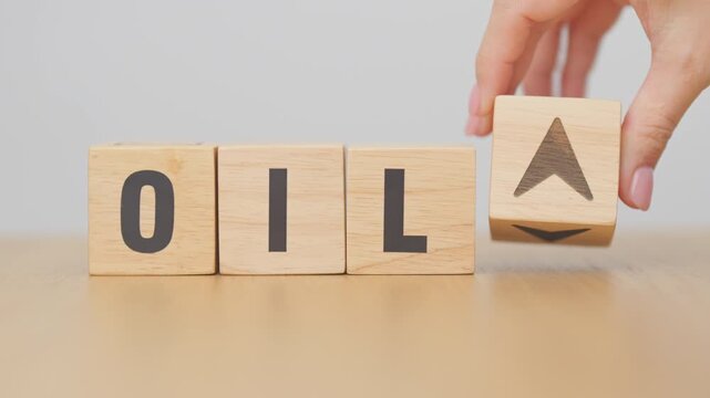 Hand change wooden block with OIL text to UP and Down arrow symbol icon. Trade war, stocks, financial, cut loss and economic concept