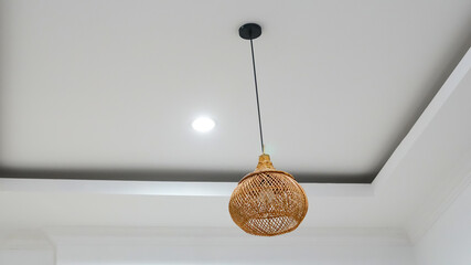 Wicker lampshade in an indoor cafe. Vintage decorative