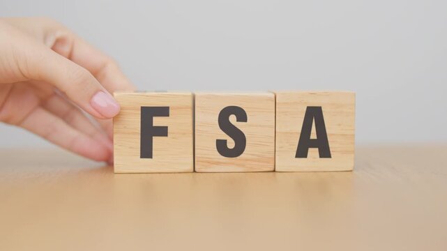 hand change wooden block from FSA to HSA. Flexible Spending Account and Health Savings Account, Medical Expenses, Tax Benefits and healthcare concepts