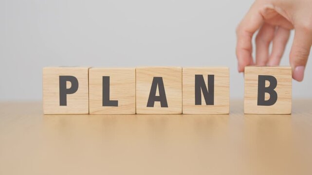 hand change wooden block PLAN A to PLAN B. strategy, leadership, management, marketing, project and finance concepts